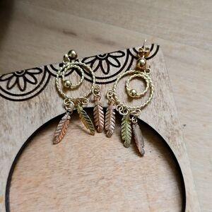 Gold stud earrings, they are stamped but I can't read it, it is so tiny.